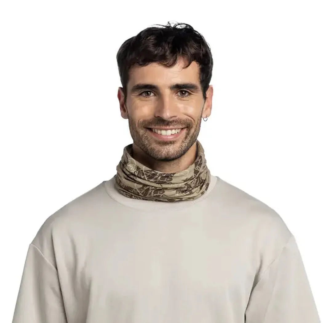 A front view of the Khaki Buff CoolNet UV Angler - Lake River worn by a smiling model against a white background.