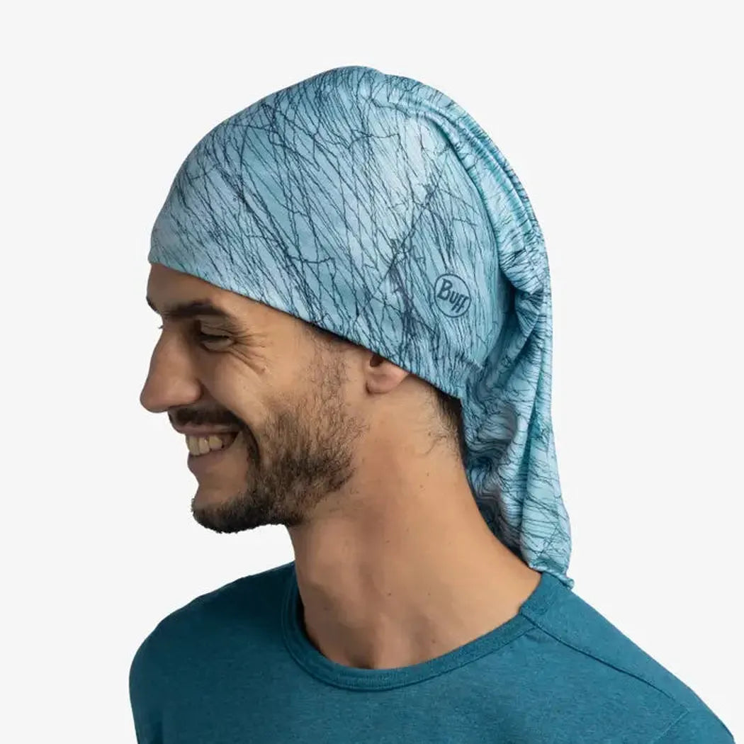 Side view of the Buff CoolNet UV Insect Shield - Colfu Pool bandana on a smiling model against a white background.