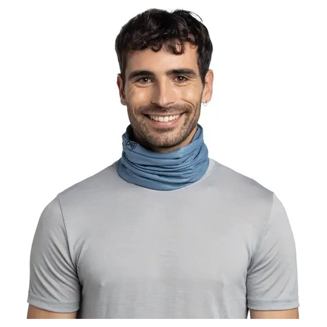A front view of the Buff CoolNet UV Insect Shield - Solid in Pistachio worn by a smiling model against a white background.