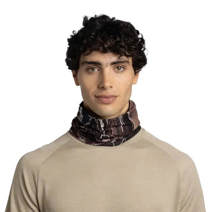 A front view of the Buff CoolNet UV Insect Shield - Teroy multi-colored bandana worn by a model against a white background.