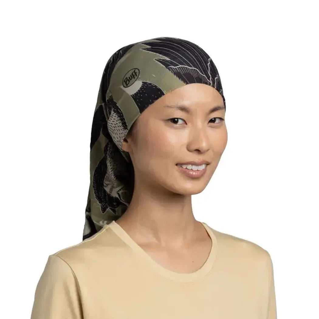 A model wears the Khaki Buff CoolNet UV - Rub Chomp bandana against a white background.