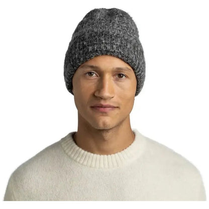 A model wears the Graphite Buff Knitted Beanie - Irna against a plain white background.