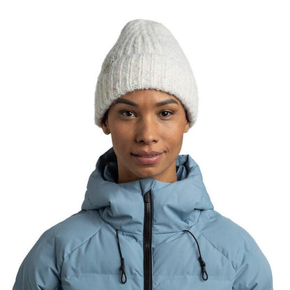 A front view of the White Buff Knitted & Fleece Band Beanie - Eyla on a model wearing a light blue puffer jacket against a white background.
