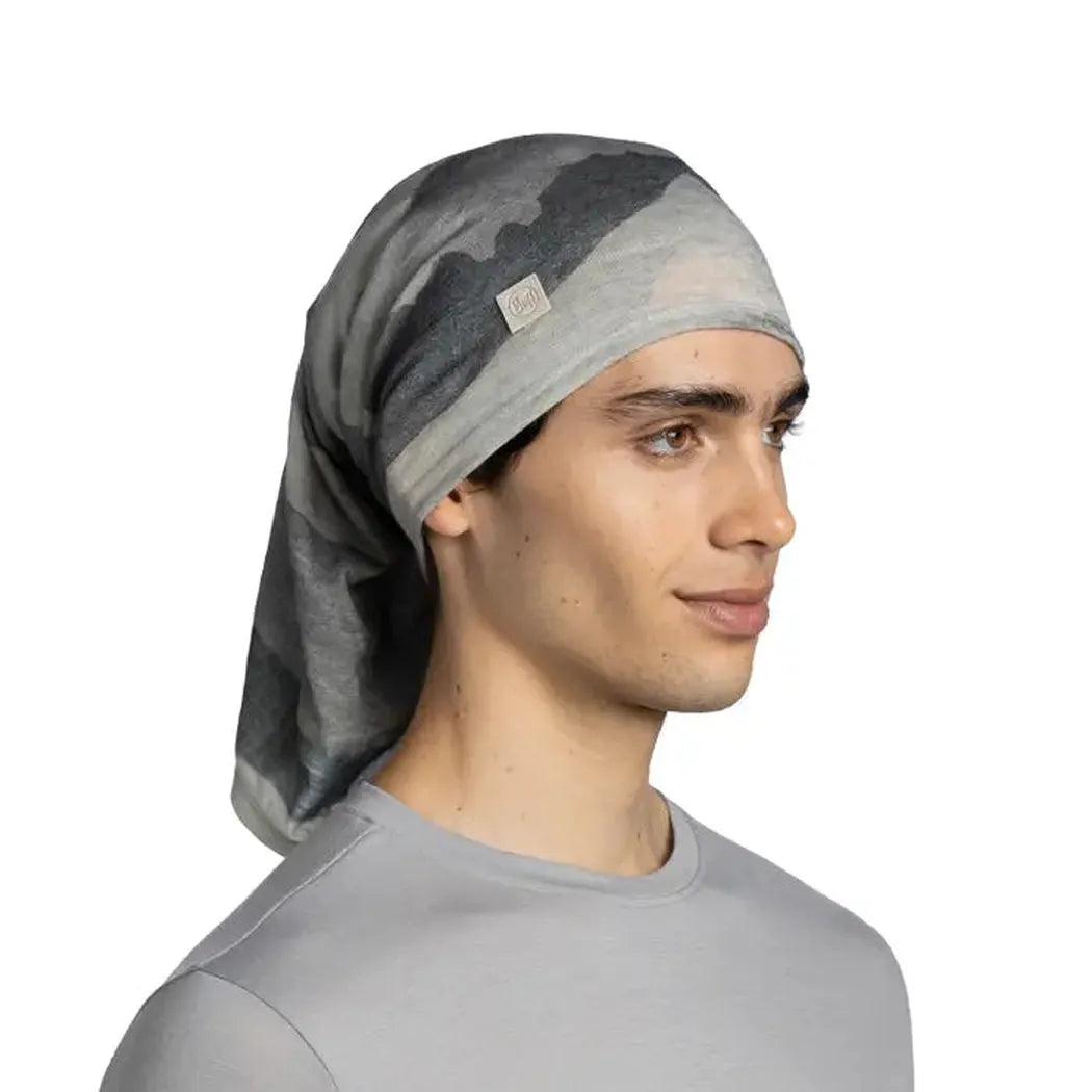 Side view of the Buff Merino Lightweight Digital Print - Aler grey bandana on a model against a white background.