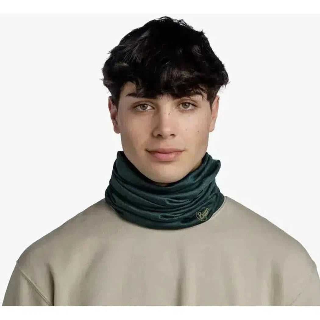 A front view of a model wearing the Lake Blue Buff Merino Lightweight - Solid bandana against a plain white background.