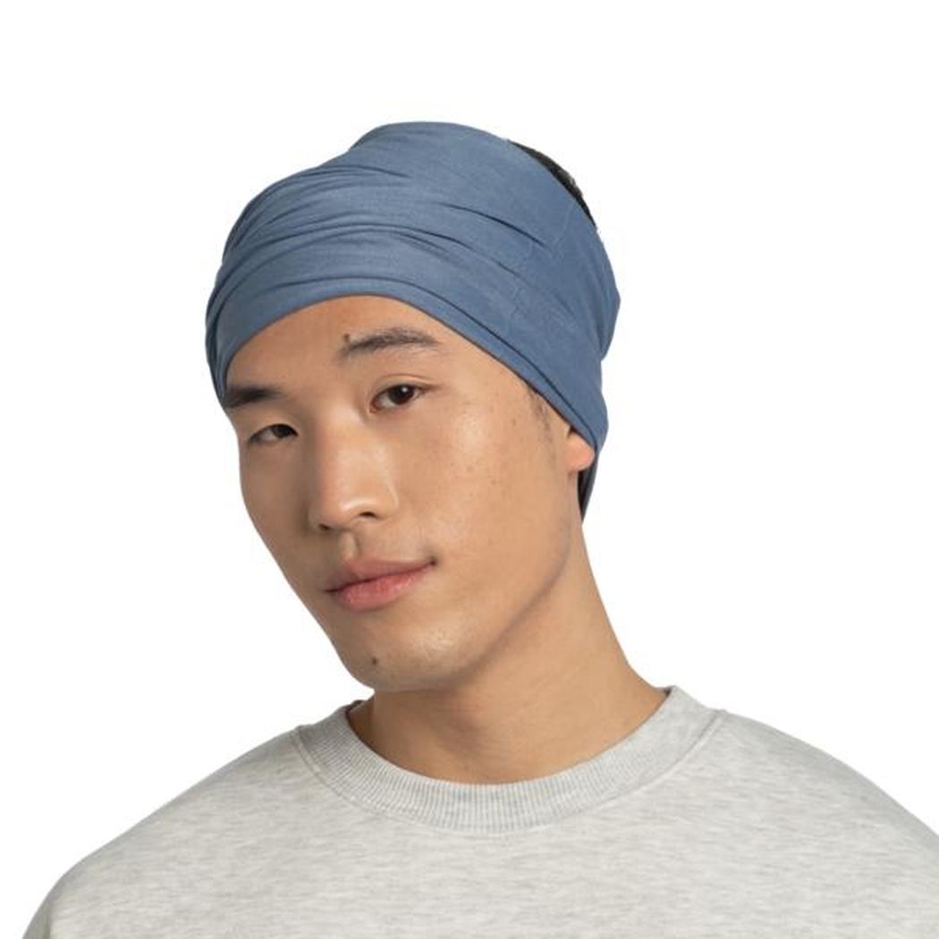 A front view of the Buff Original EcoStretch - Solid Water bandana on a model wearing a gray shirt against a white background.