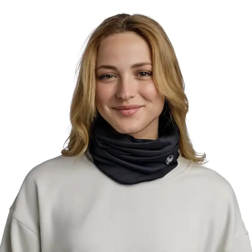 A model wears the black Buff Windproof - Solid neck gaiter against a plain white background.
