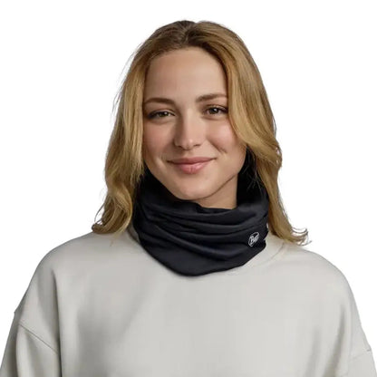A model wears the black Buff Windproof - Solid neck gaiter against a plain white background.
