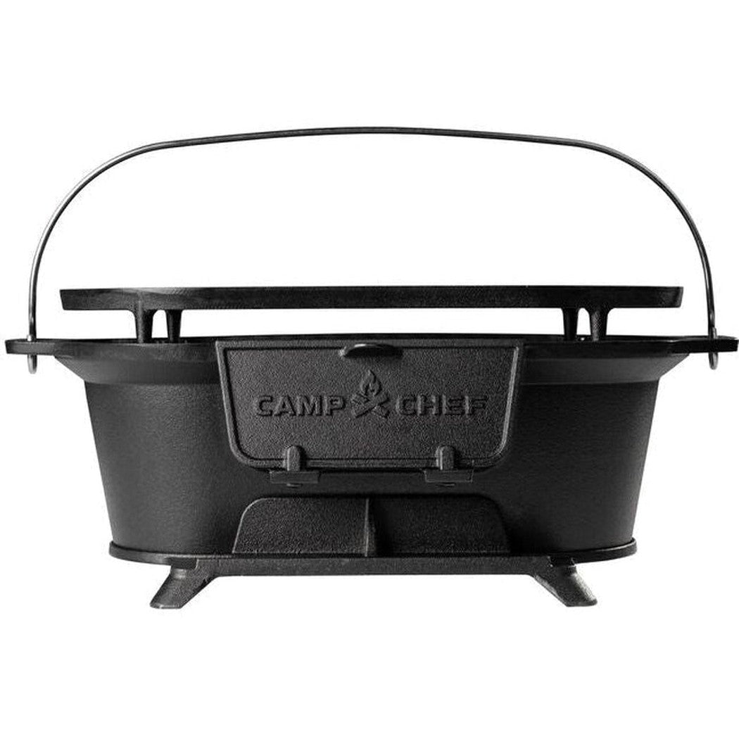 Back view of the Camp Chef Cast Iron Charcoal Grill with a black handle and stand against a white background.