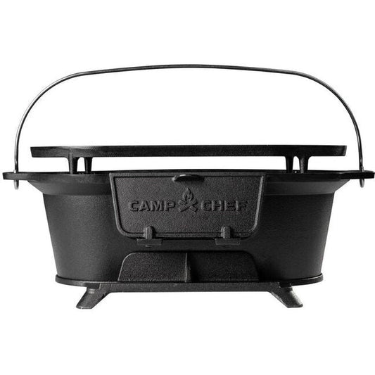 Back view of the Camp Chef Cast Iron Charcoal Grill with a black handle and stand against a white background.