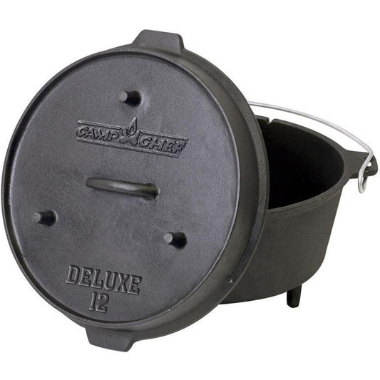 A top-down view of the Camp Chef Cast Iron Deluxe Dutch Oven 12" with its lid off, showing the interior and three legs.