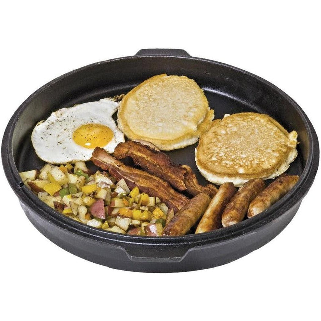 A top-down view of the Camp Chef Cast Iron Deluxe Dutch Oven 12" filled with breakfast items like eggs, pancakes, and sausages.