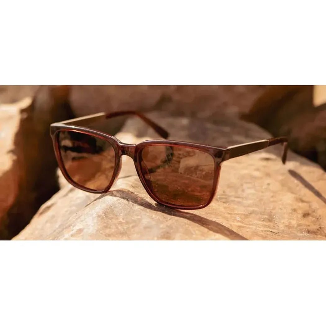 A pair of Camp Eyewear Crag - Arches Edition sunglasses rests on a large rock in a natural outdoor setting.
