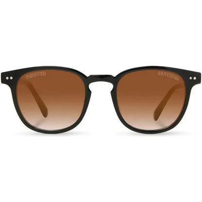 Black Camp Eyewear Topo: Grateful Dead Stealie Edition sunglasses with brown gradient lenses and engraved "Grateful" on the right lens, shown front on against a white background.