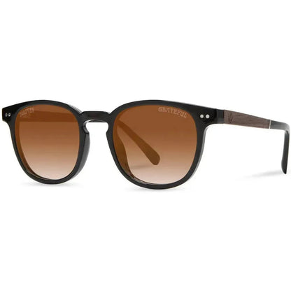 Side view of the Camp Eyewear Topo: Grateful Dead Stealie Edition sunglasses with black frames and brown lenses against a white background.