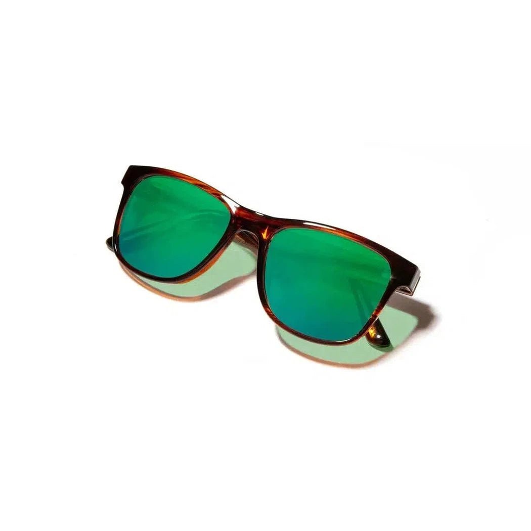 Side view of the Camp Eyewear Trail sunglasses with black frames and green lenses against a white background.