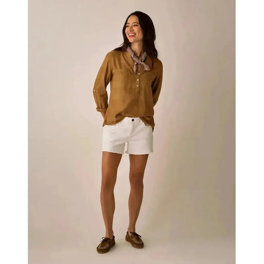 A woman wearing the Carve Designs Women's Dylan Textured Shirt in Golden stands against a neutral background.