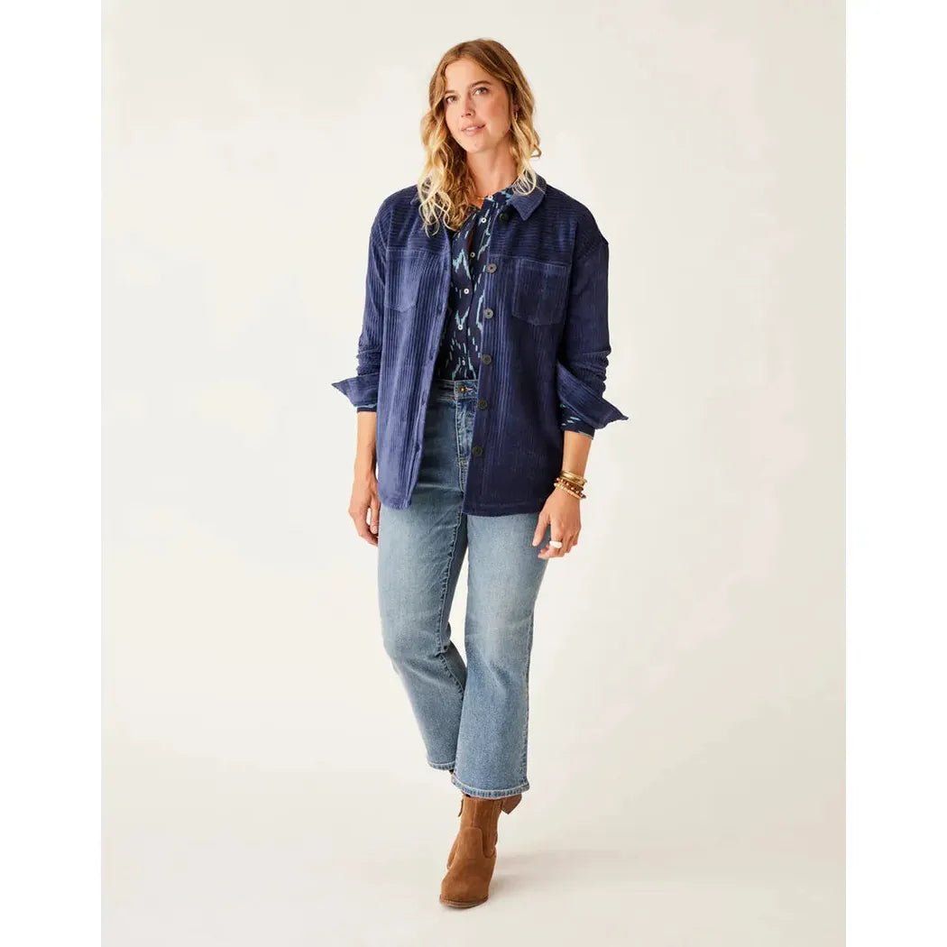 A model wearing the Carve Designs Women's Hudson Stretch Cord Shacket in Navy stands against a plain white background.