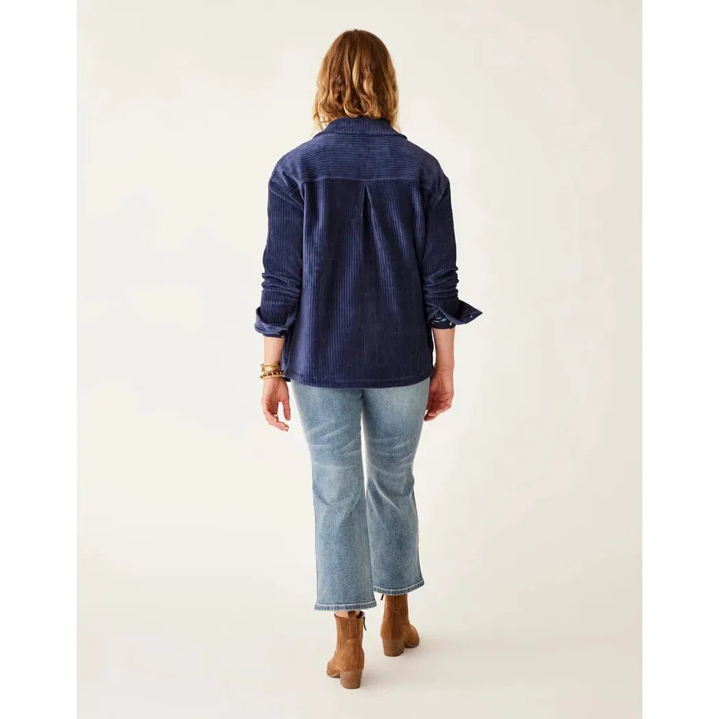 Back view of the Carve Designs Women's Hudson Stretch Cord Shacket in Navy on a model wearing cropped jeans and ankle boots against a white background.