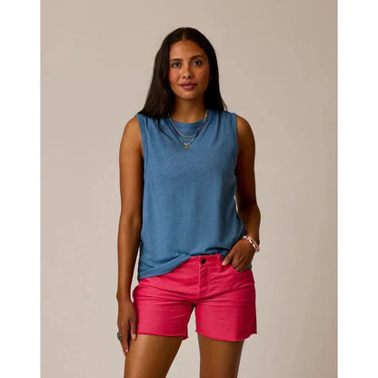 A woman wearing the Carve Designs Women's Larisa Hemp Tank in Captain blue and pink shorts stands against a neutral background.