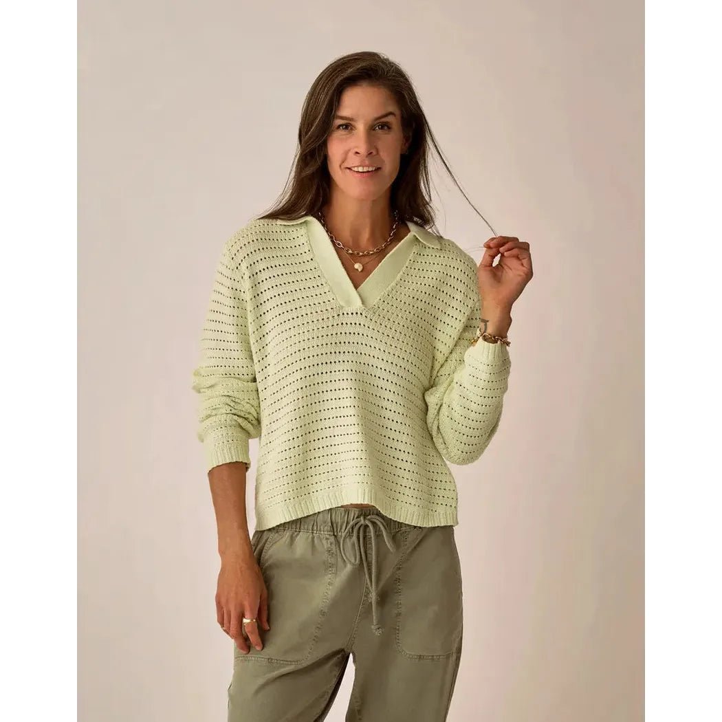 A woman wearing the Carve Designs Women's Morgan Polo Sweater in Cloud stands against a neutral background.