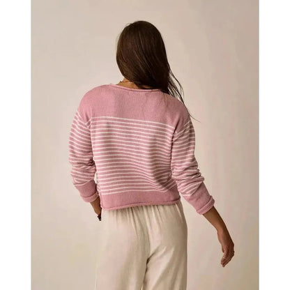 Back view of the Carve Designs Women's Rue Sweater in Light Dusk Stripe on a model wearing white pants against a plain background.
