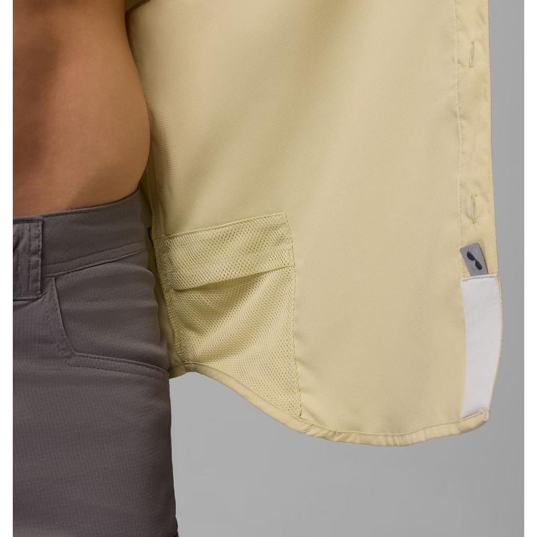 Side view of the Columbia Sportswear Men's Blood and Guts V Short Sleeve Shirt in White showing the pocket and tag against a gray background.