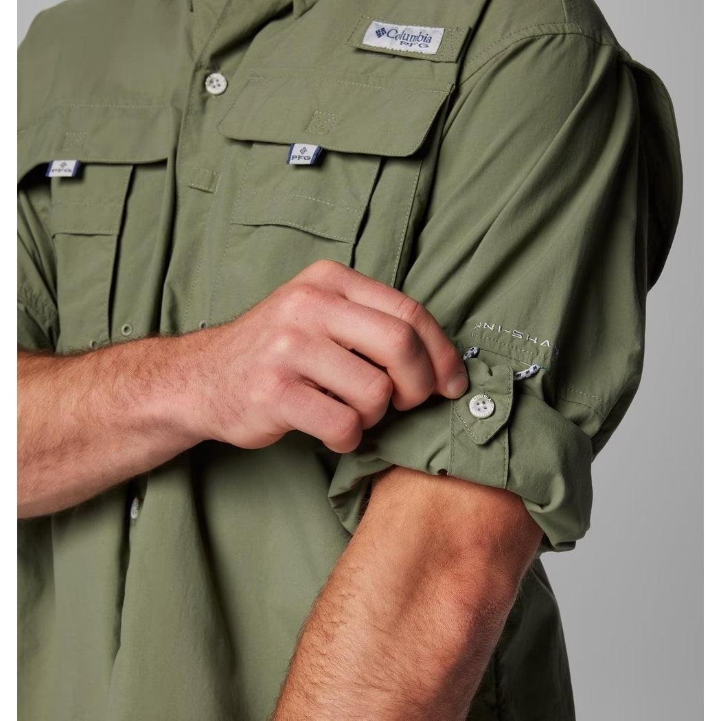 A close-up of the Columbia Sportswear Men's PFG Bahama II Long Sleeve Shirt in Fossil, showing the rolled-up sleeve and chest pockets against a plain background.