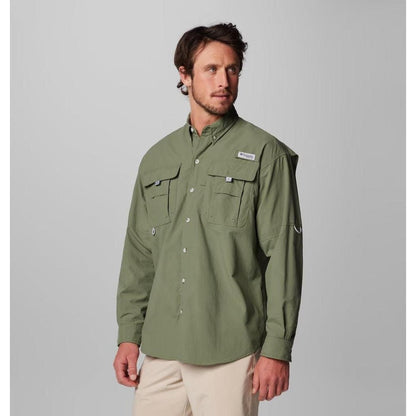 A front view of the Columbia Sportswear Men's PFG Bahama II Long Sleeve Shirt in Fossil, showing chest pockets and a model wearing it against a light gray background.