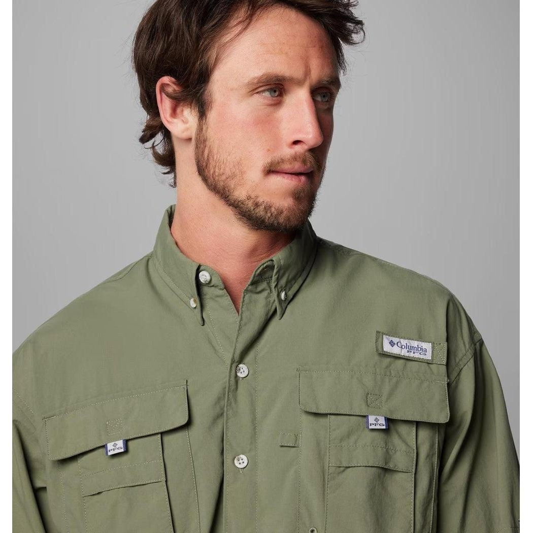 A front view of the Columbia Sportswear Men's PFG Bahama II Long Sleeve Shirt in Fossil color showing the chest pockets and brand tag against a gray background.
