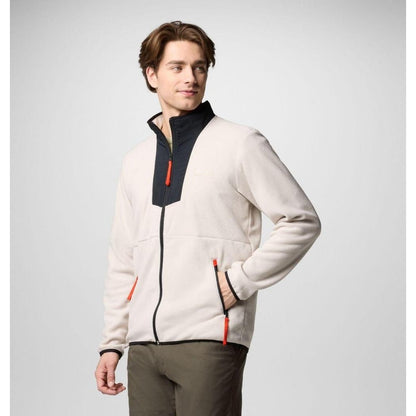 A man in a side view wearing the Columbia Sportswear Men's Sequoia Grove Full Zip Fleece with a dark collar and red zipper pulls against a light gray background.