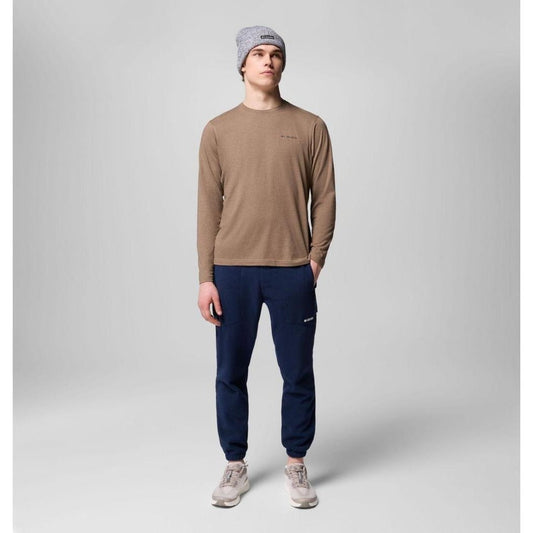 A model wearing Columbia Sportswear Men's Sequoia Grove Pants in Collegiate Navy stands against a plain gray background.