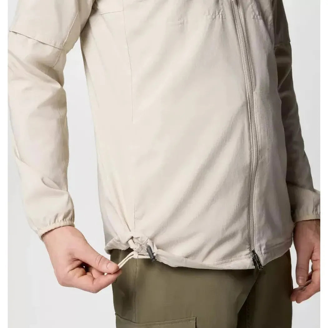 A side view of the Columbia Sportswear Men's Skien Valley Hooded Long Sleeve Shirt in Dark Stone showing the hem drawcord against a plain background.