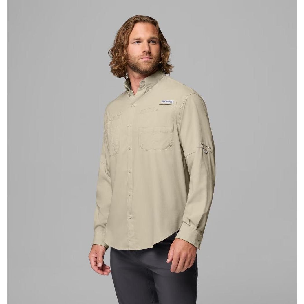 A man wearing the Columbia Sportswear Men's Tamiami II Long-Sleeve Shirt in Fossil stands against a gray background.