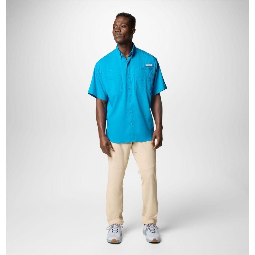 A model wearing the Columbia Sportswear Men's Tamiami II Short-Sleeve Shirt in Blue Echo stands against a plain white background.