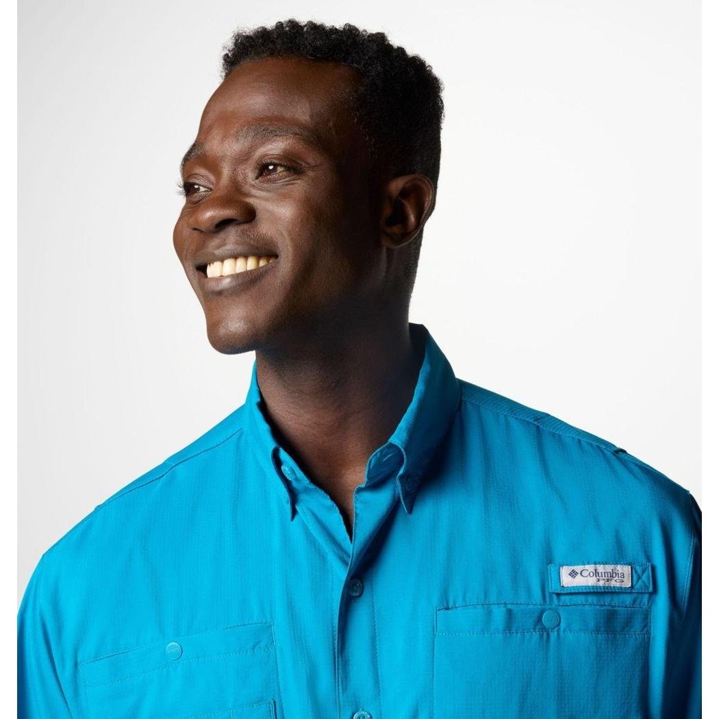 A side view of the Columbia Sportswear Men's Tamiami II Short-Sleeve Shirt in Blue Echo showing the chest pocket and logo against a white background.
