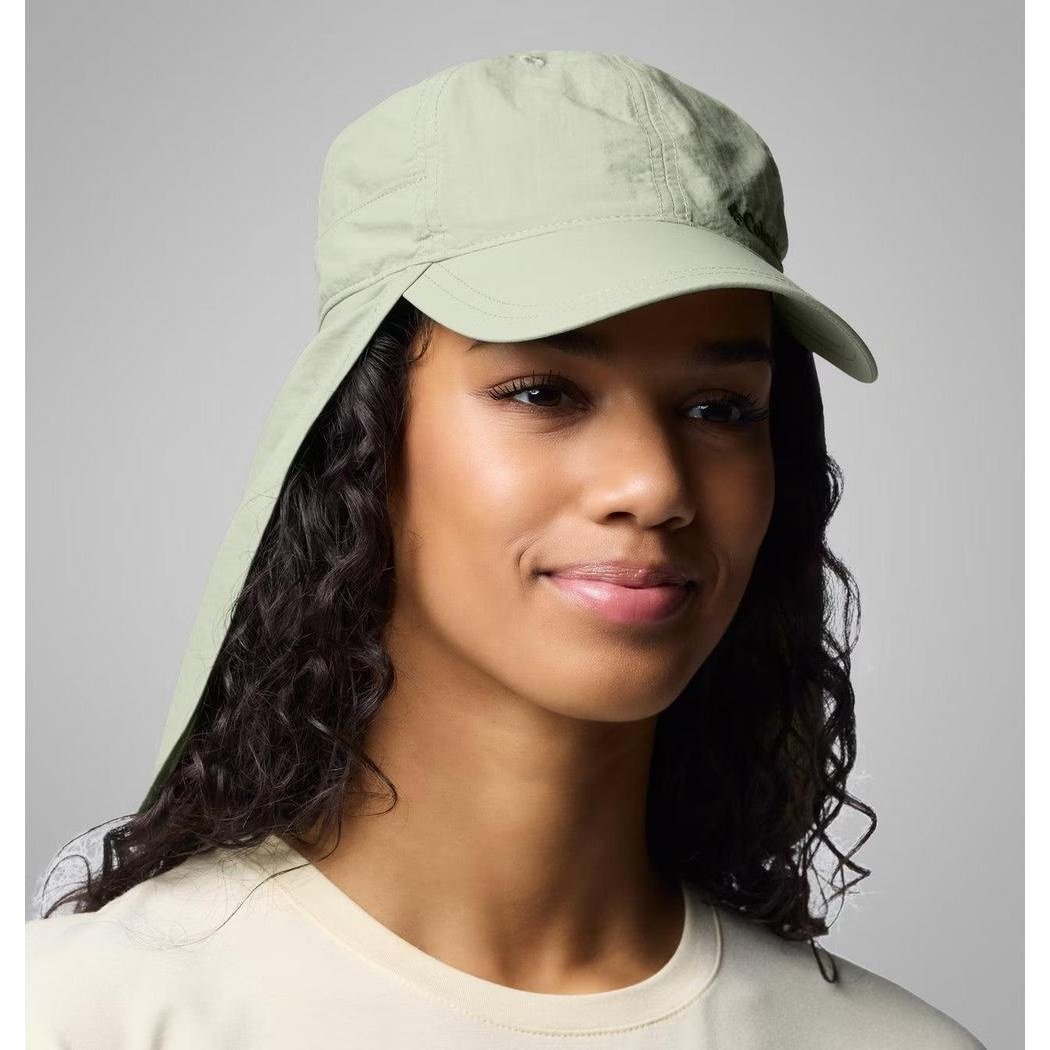 A model wears the Ancient Fossil Columbia Sportswear Schooner Bank II Cachalot hat with a wide brim and neck flap against a plain gray background.