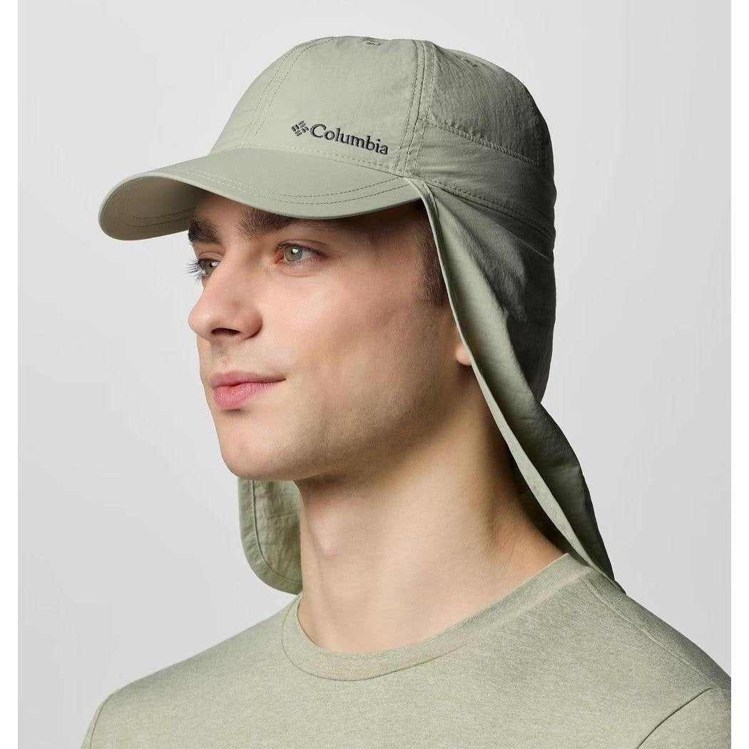 A side view of the Ancient Fossil Columbia Sportswear Schooner Bank II Cachalot hat with neck flaps, worn by a model against a plain background.