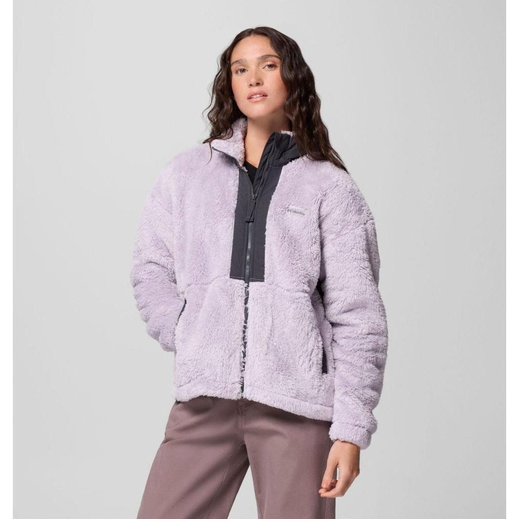 A woman wearing the Columbia Sportswear Women's Boundless Discovery Sherpa Full Zip II Jacket in Chalk/Camel Brown stands against a light gray background.