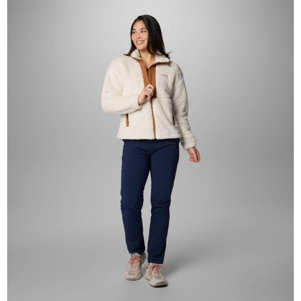 A woman wearing the Columbia Sportswear Women's Boundless Discovery Sherpa Full Zip II Jacket in Chalk/Camel Brown stands against a gray background.