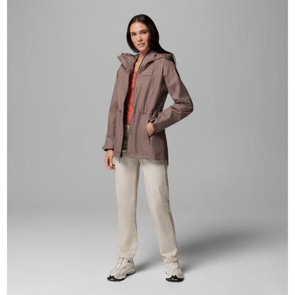 A model wearing the Columbia Sportswear Women's Hikebound II Long Jacket in Iron stands against a gray background.