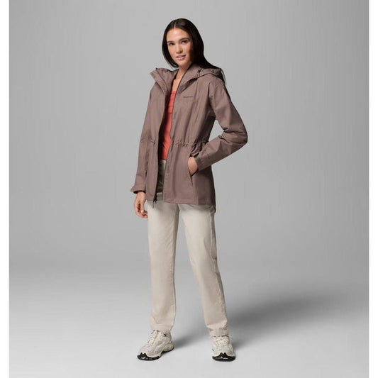 A model wearing the Columbia Sportswear Women's Hikebound II Long Jacket in Iron stands against a gray background.