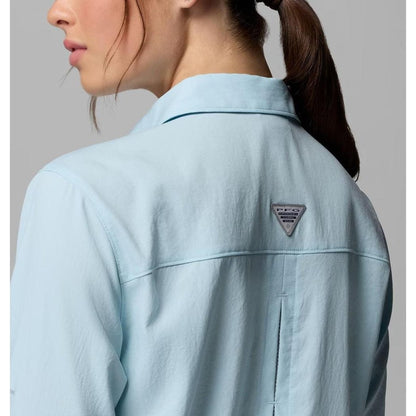 Back view of the Columbia Sportswear Women's PFG Castback Woven Long Sleeve in Marine Light showing the logo on the back against a gray background.