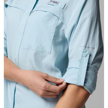 A close-up of the Columbia Sportswear Women's PFG Castback Woven Long Sleeve in Marine Light, showing the rolled-up sleeve and chest pocket.