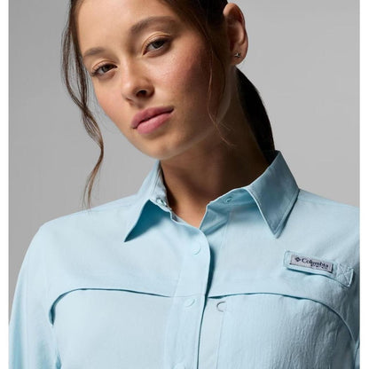A front view of the Columbia Sportswear Women's PFG Castback Woven Long Sleeve in Marine Light shows the brand tag and collar against a neutral background.