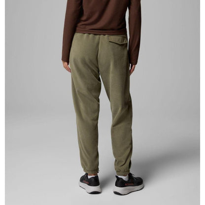 Back view of the Columbia Sportswear Women's Sequoia Grove Fleece Pants in Stone Green on a model wearing black sneakers against a gray background.