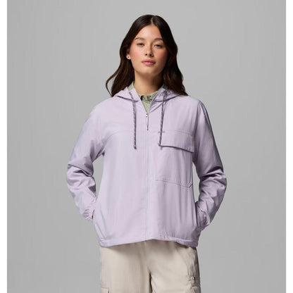 A model wearing the Columbia Sportswear Women's Skien Valley Hooded Long Sleeve Shirt in Lavender Pearl stands against a gray background.