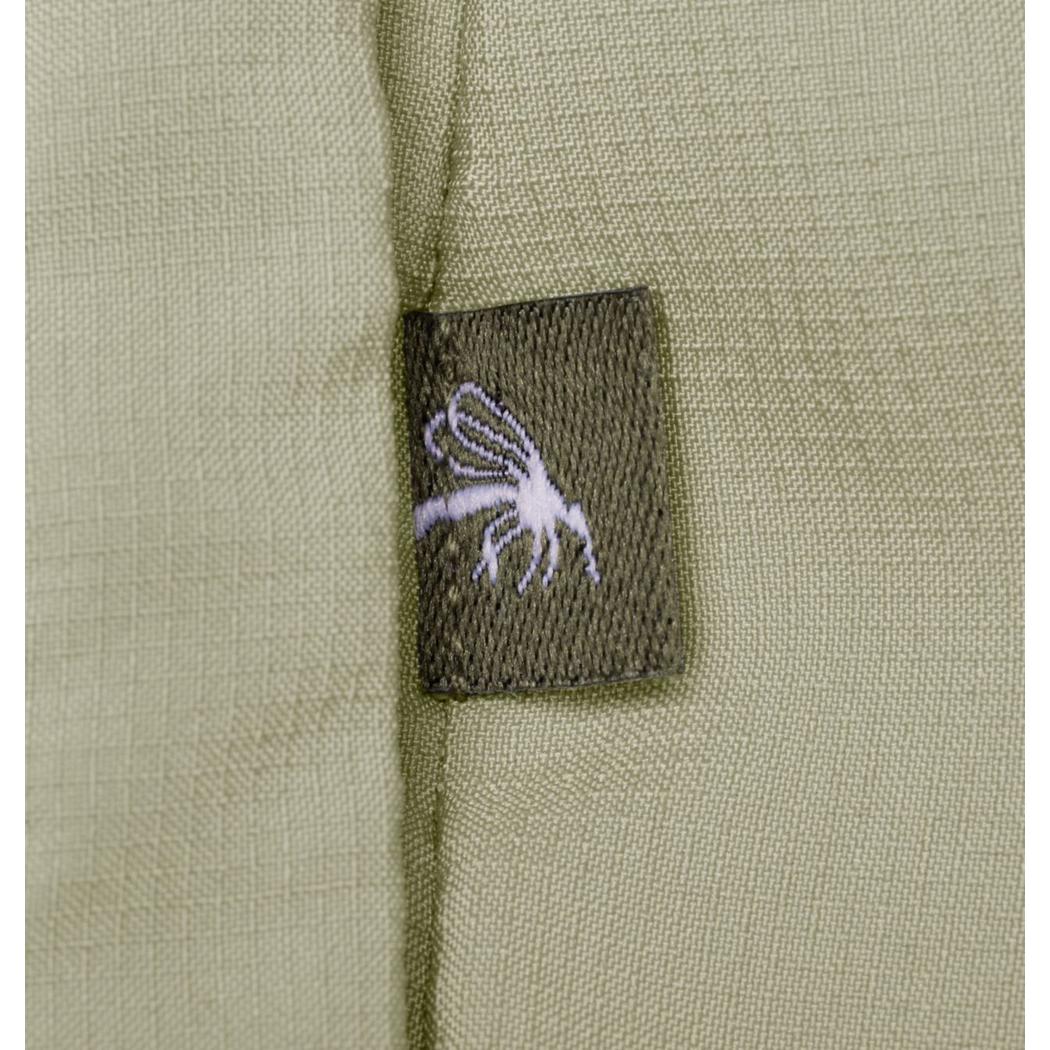 A close-up of the Columbia Sportswear Women's Skien Valley Hooded Long Sleeve Shirt in Lavender Pearl showing the charcoal tag with a white graphic on the olive fabric.