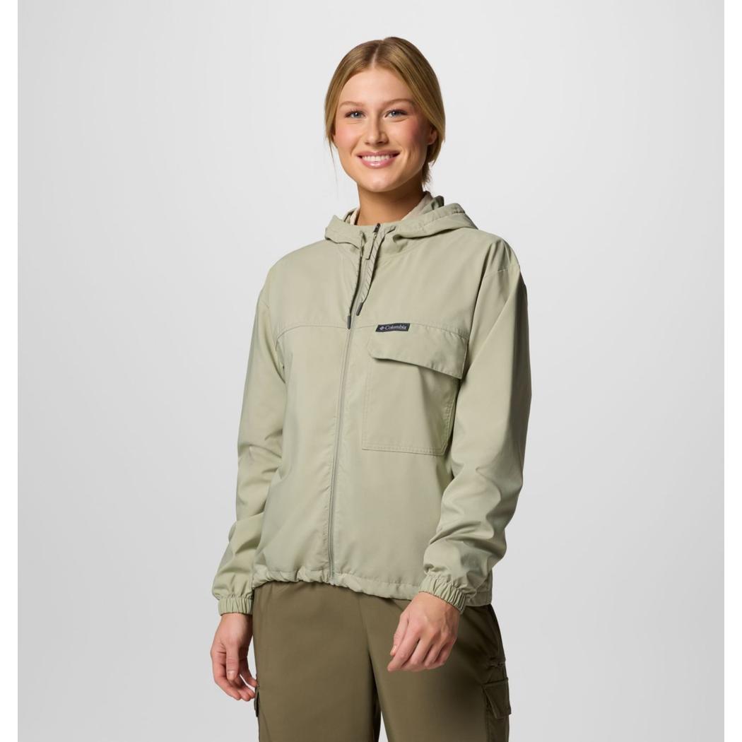 A woman wearing the Columbia Sportswear Women's Skien Valley Hooded Long Sleeve Shirt in Lavender Pearl stands against a plain background.