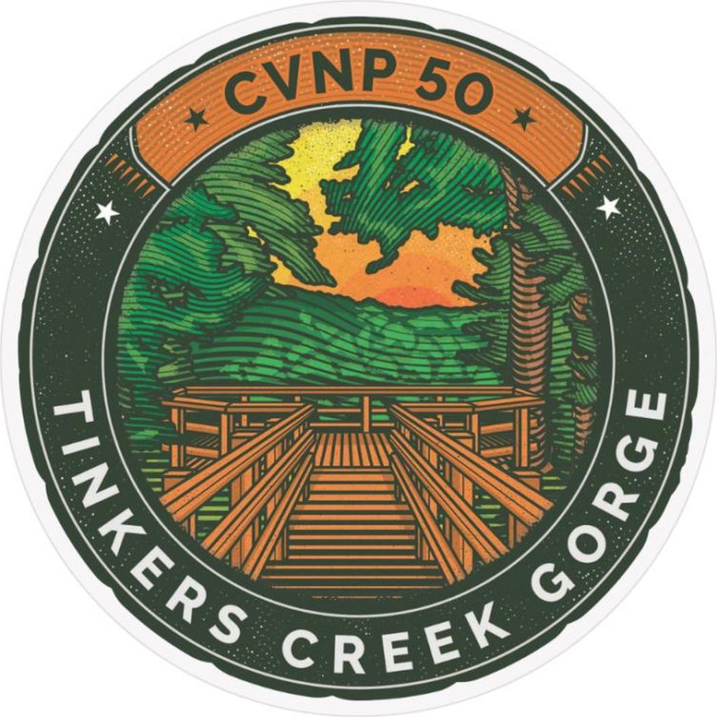 A circular sticker for the Conservancy for CVNP Tinkers Creek 50th Anniversary shows a wooden bridge over a gorge with trees and a sunset.